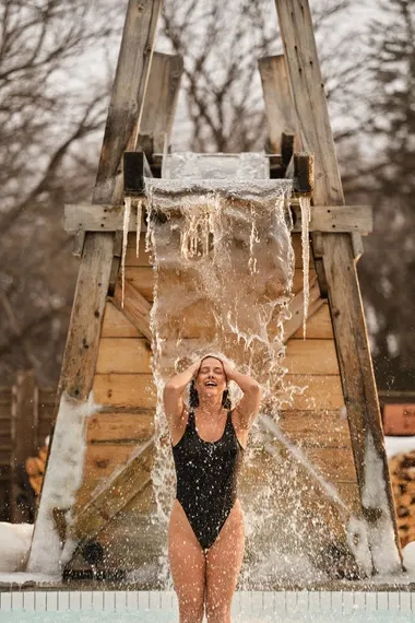 woman under a cold waterfall