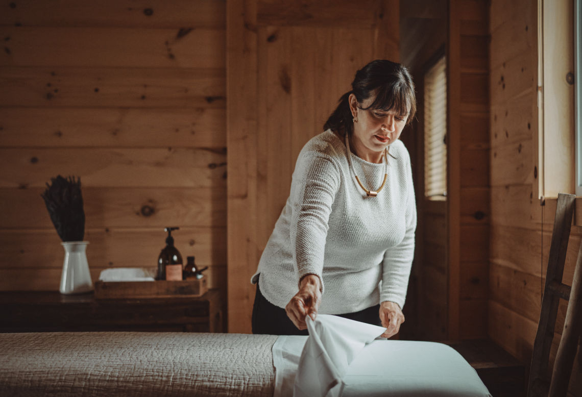 massage therapist dressing the massage bed