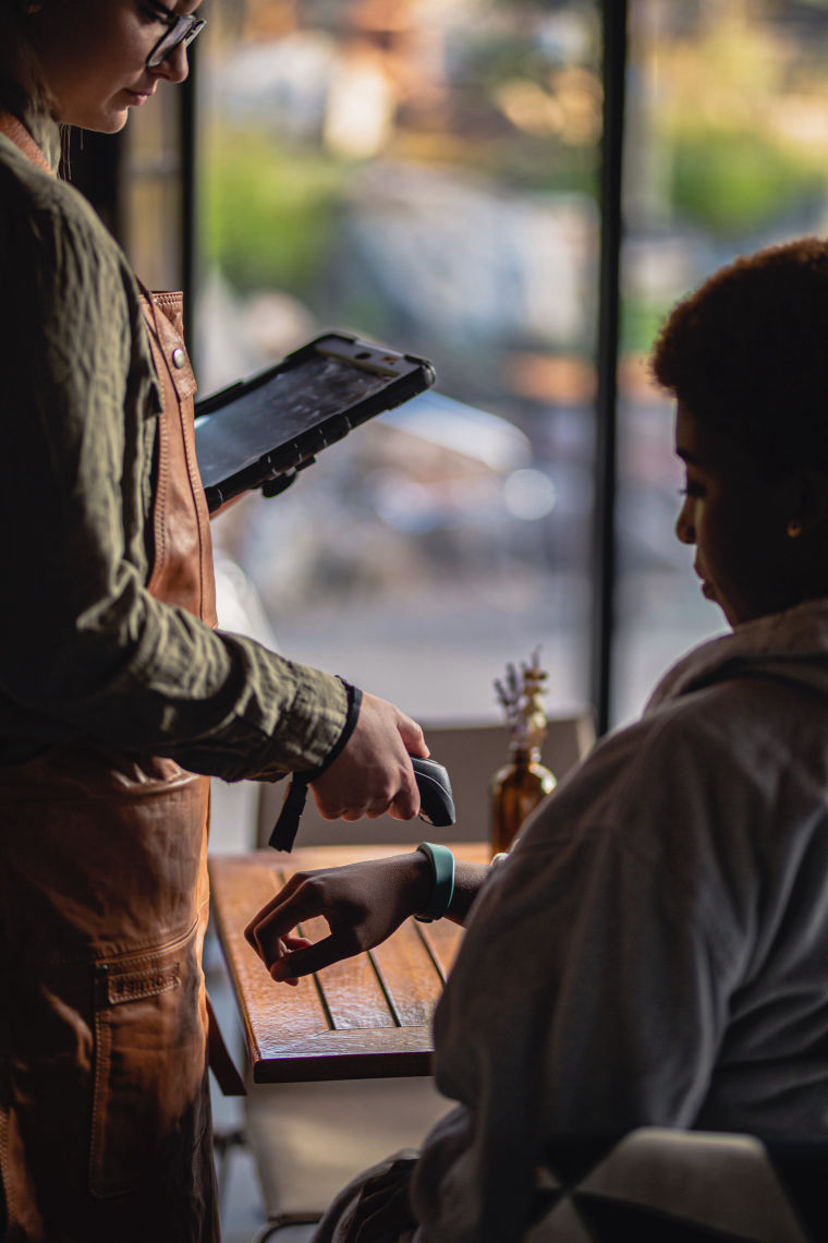 employee scanning guest rfid bracelet in restaurant