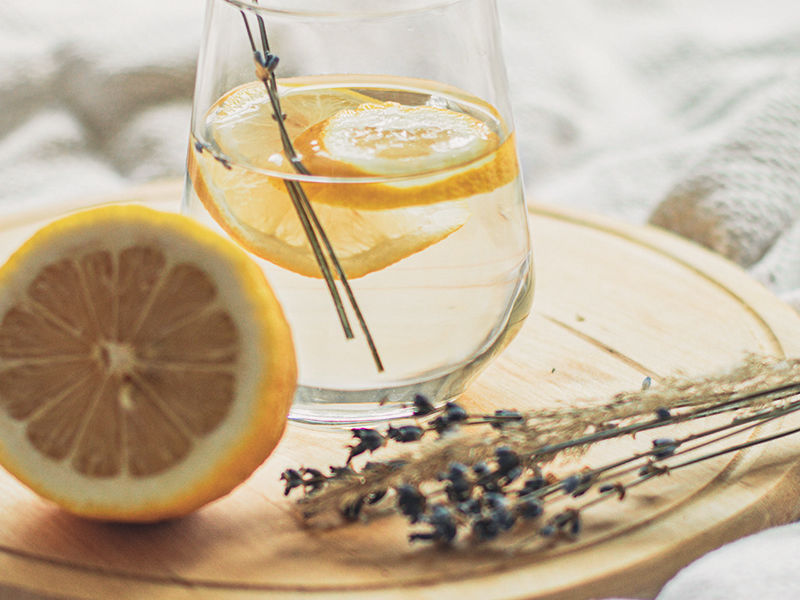 glass of lemon water with lavender