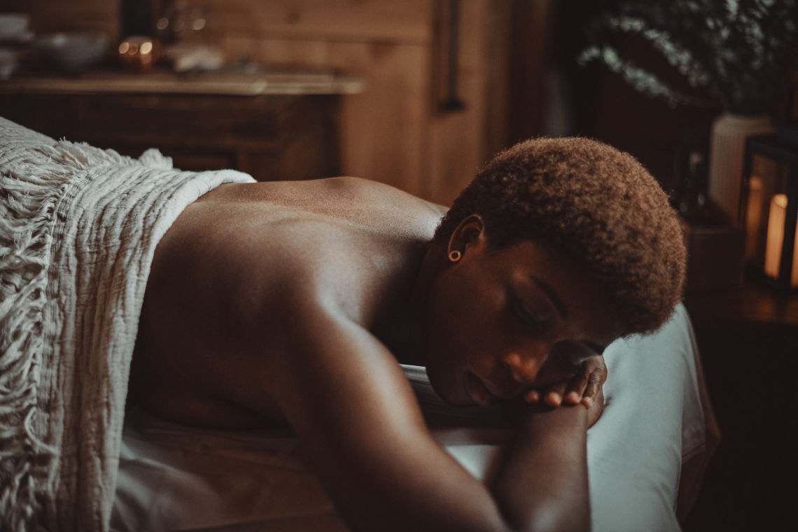 woman laying on a body treatment table