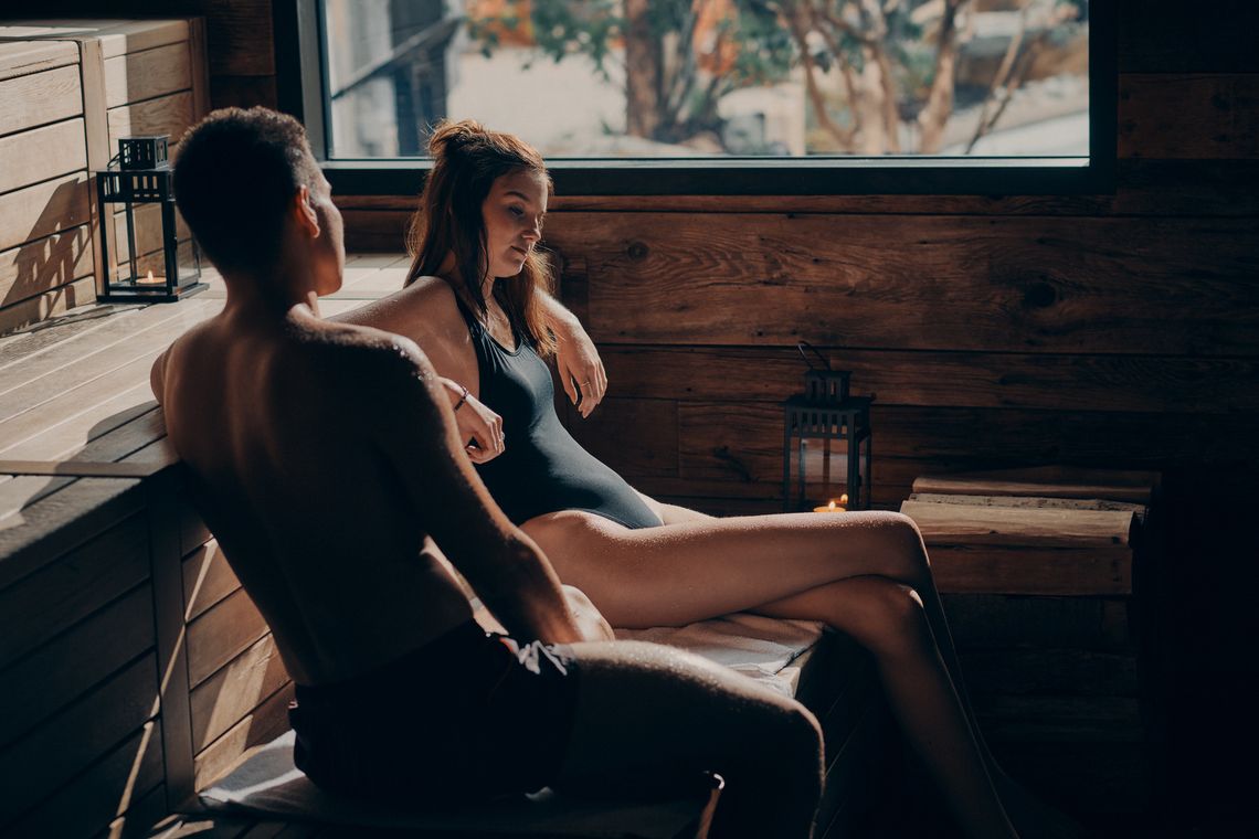 couple sitting in sauna