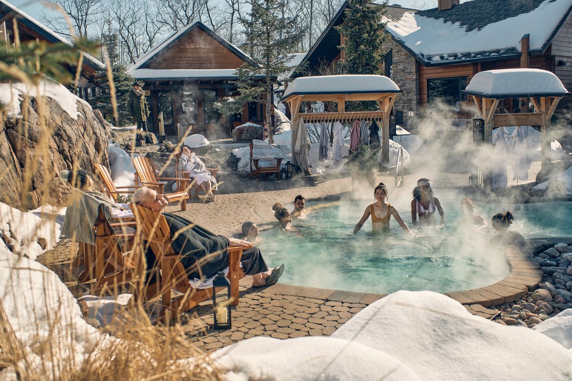 people enjoying outdoor baths in snow