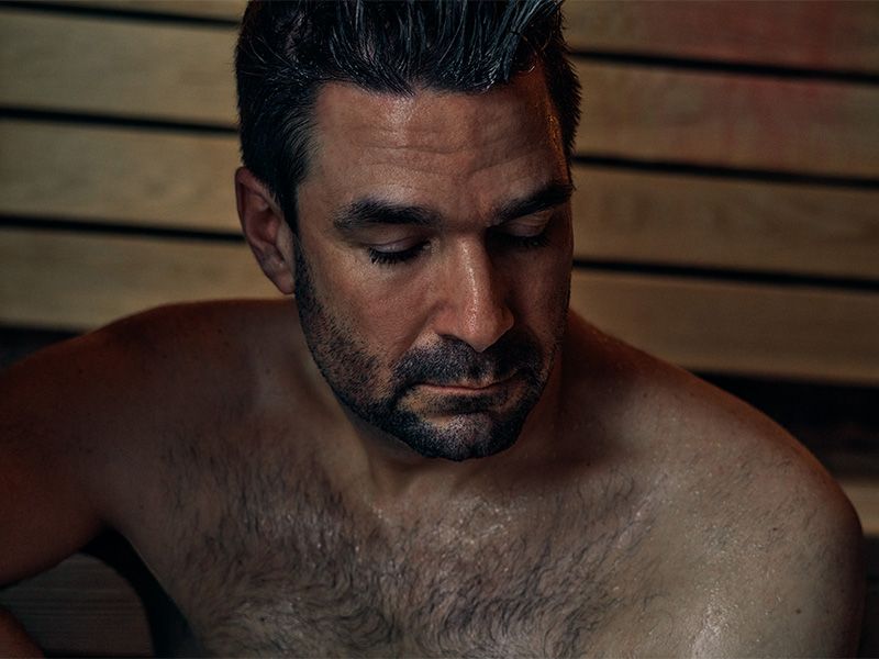 man relaxing in sauna