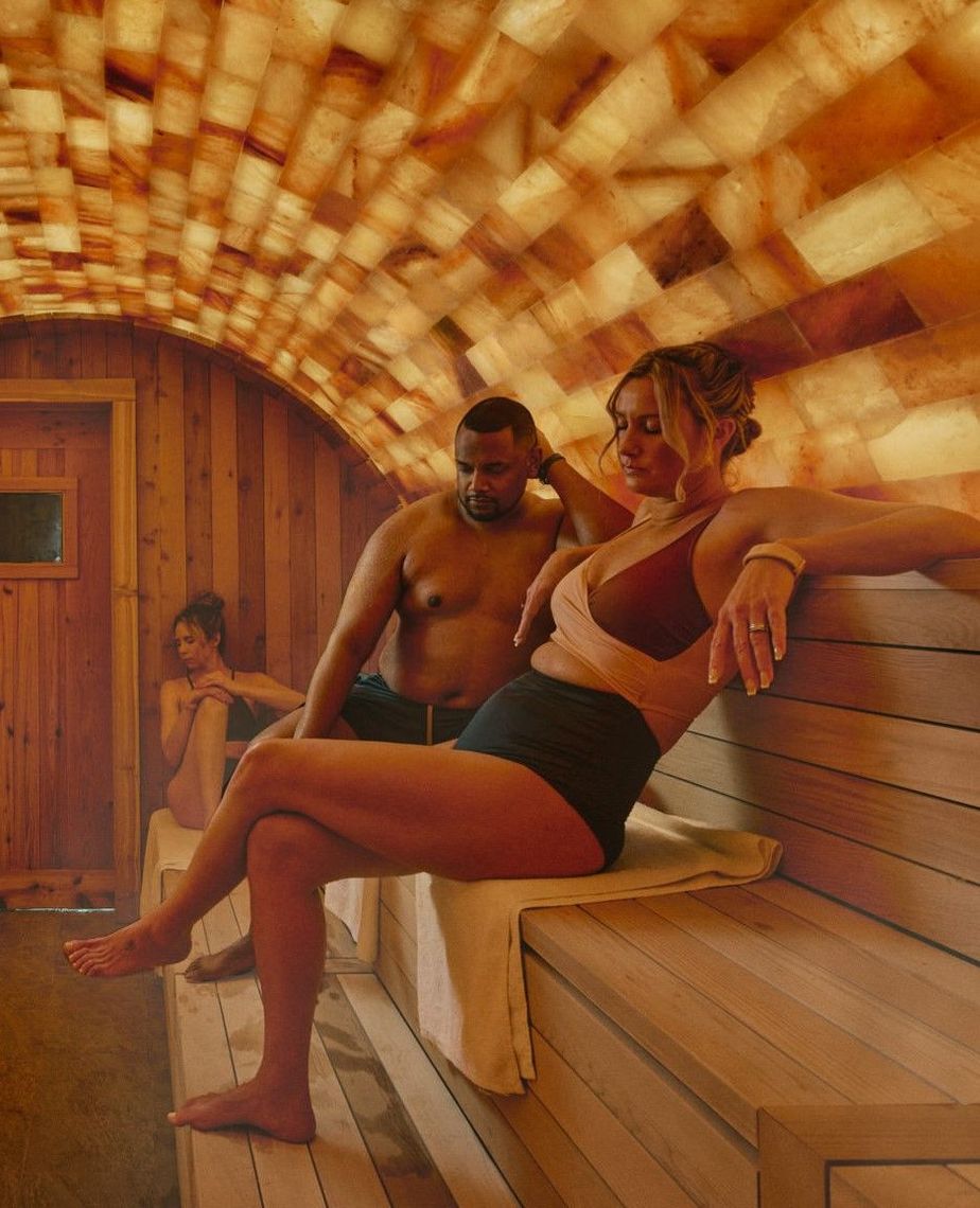 couple sitting in halo pink salt sauna