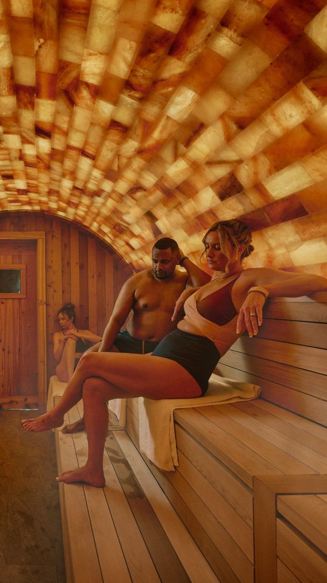 couple sitting in halo pink salt sauna