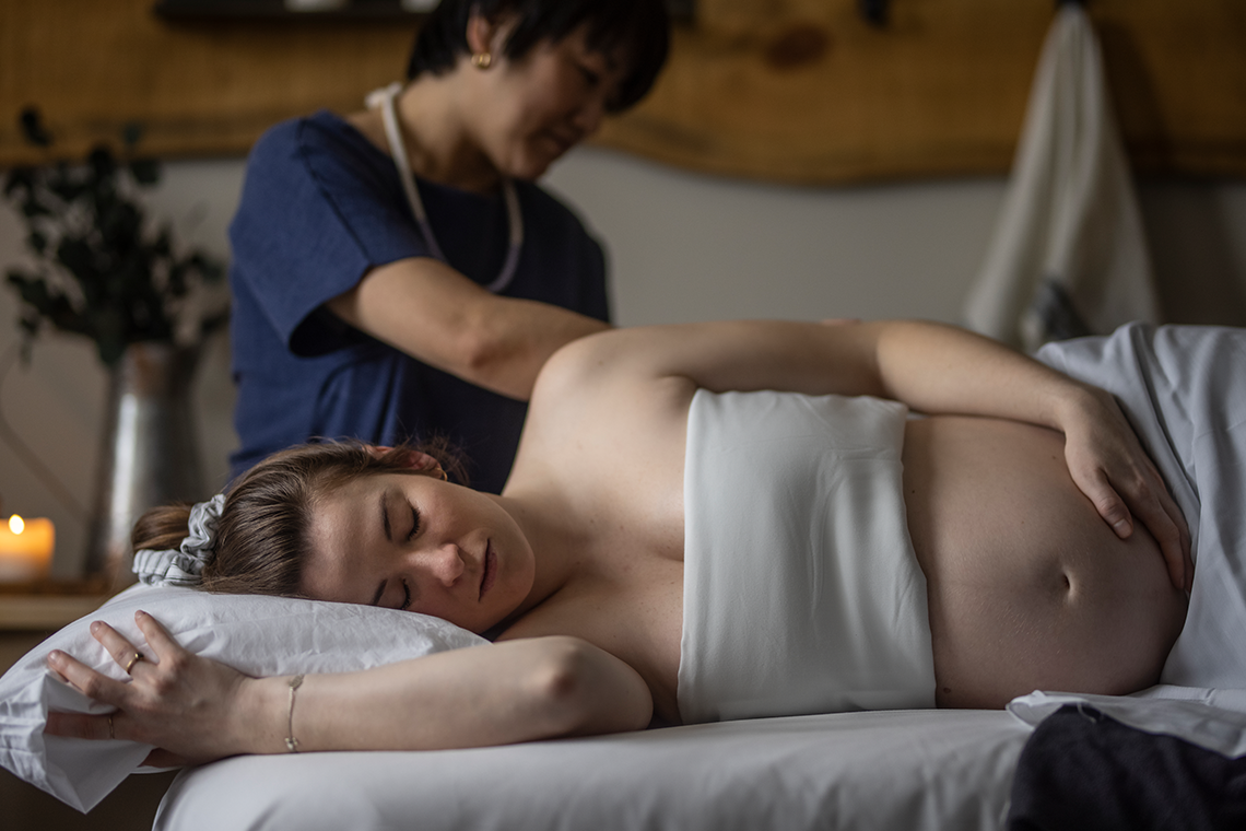 pregnant woman receiving a massage
