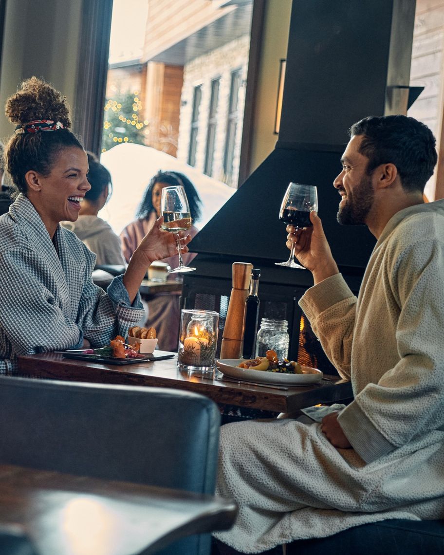 couple eating in a restaurant with glasses of wine