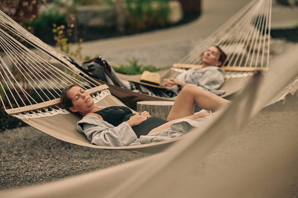 spa goers relaxing in the hammocks