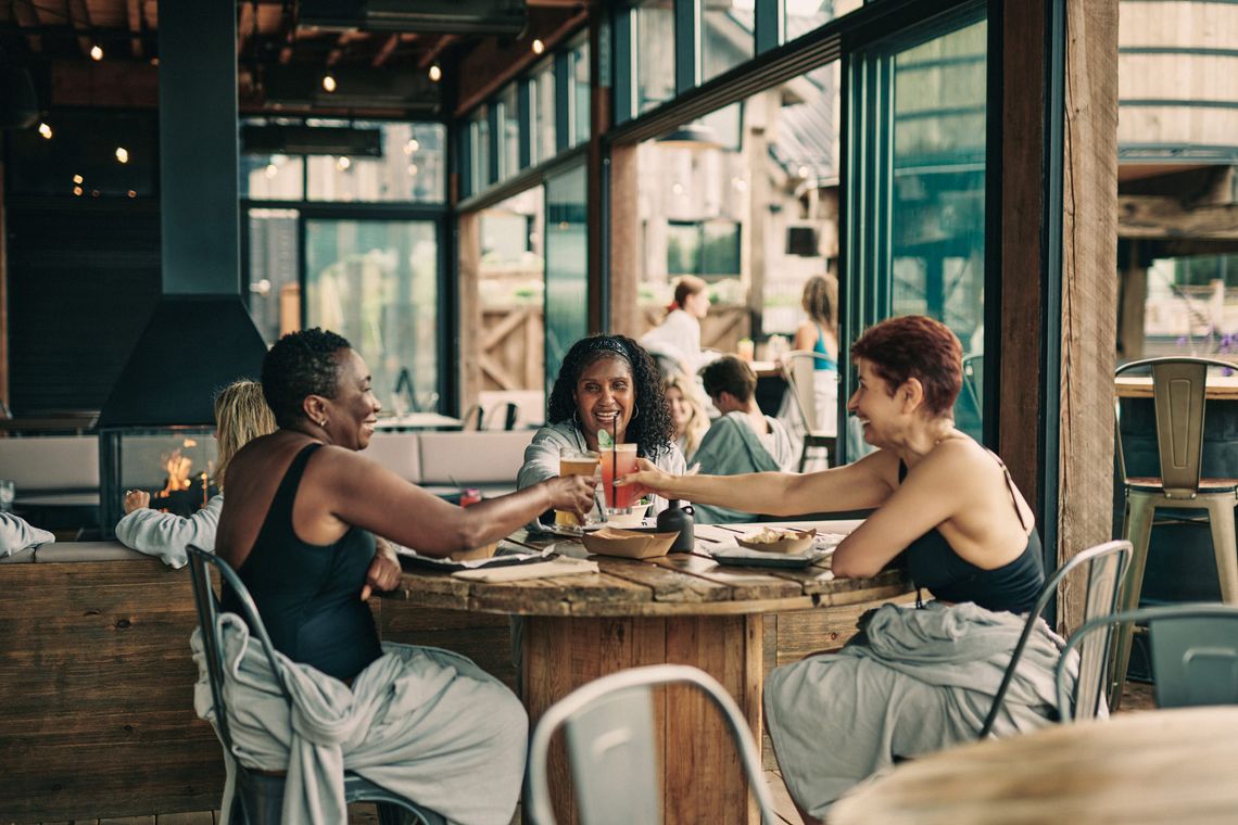 women sharing a drink on the biergarden patio