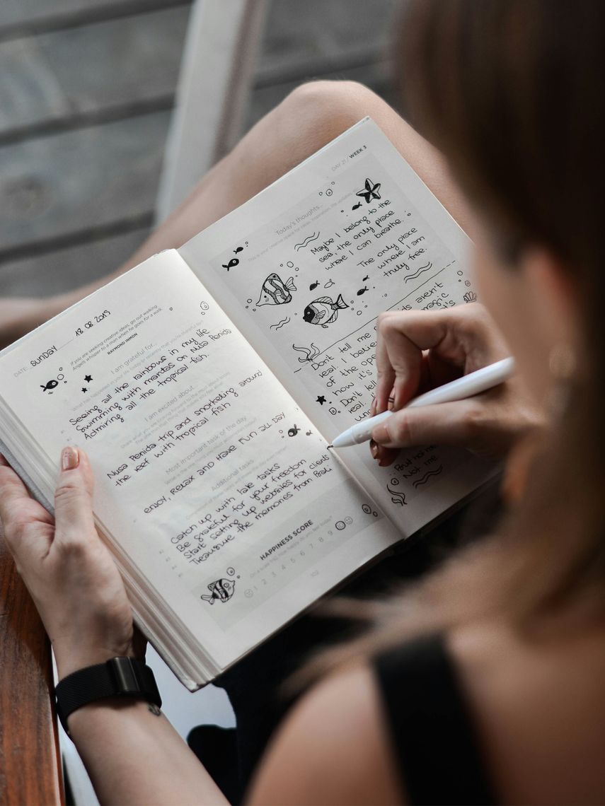 women doodling in a notebook