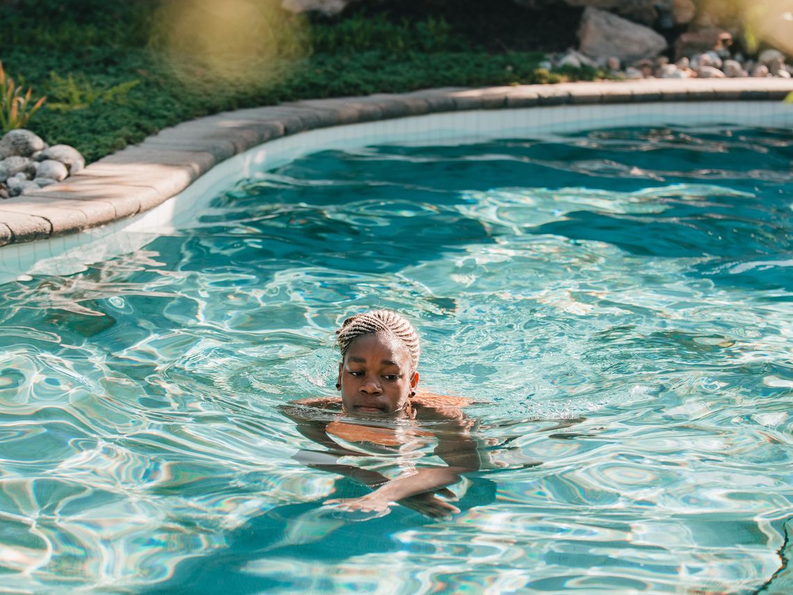 child swimming in a thermal pool on family day