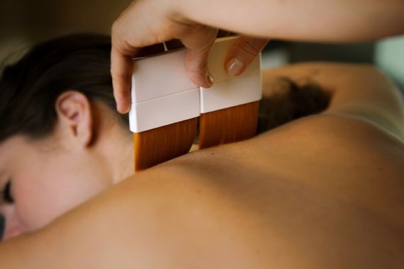 artisan using brushes during a treatment