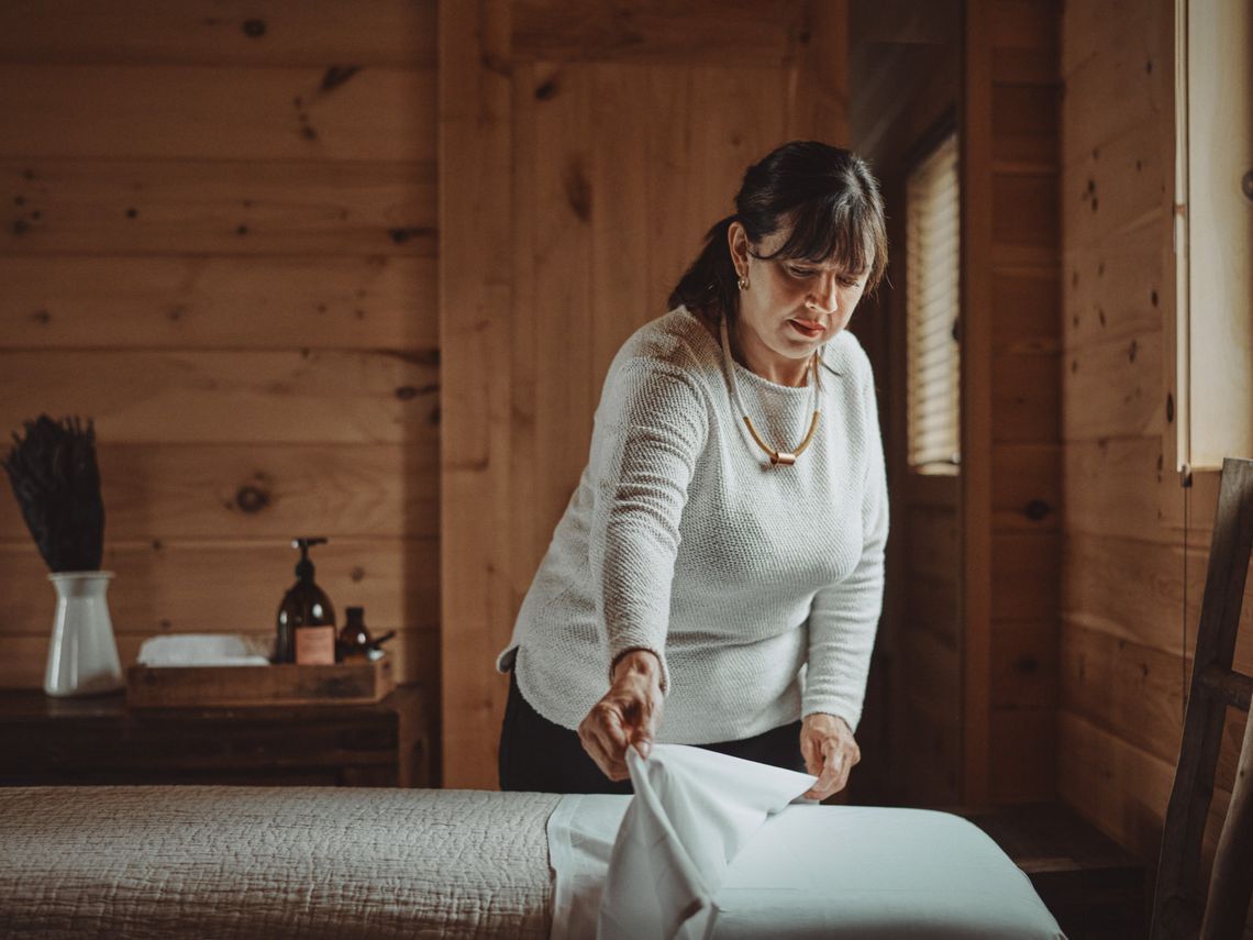 woman preparing a body care treatment bed