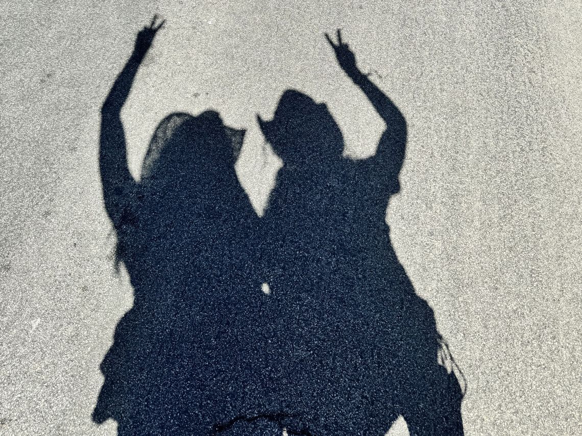 shadows of people wearing cowboy hats