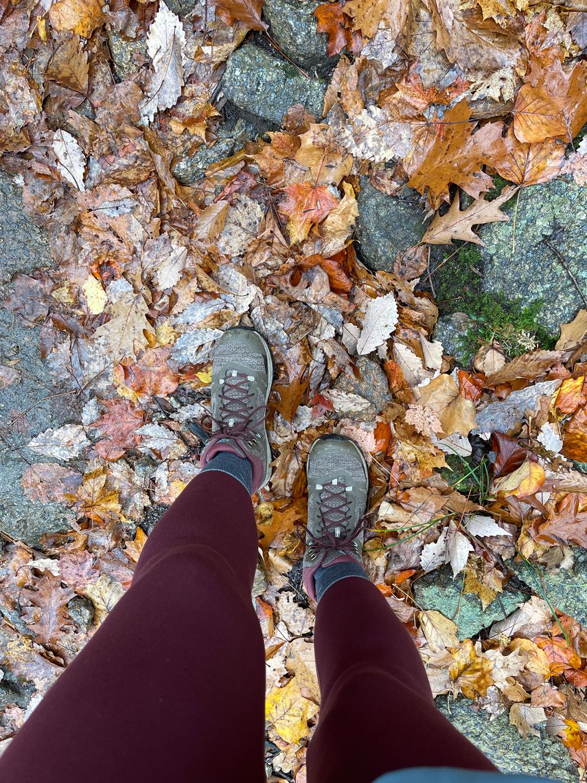 hiker, stones and autumn leaves