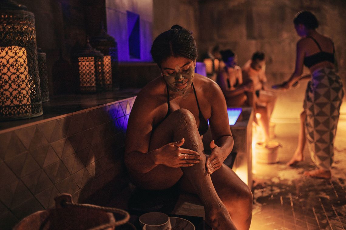 woman applying rhassoul clay to her skin