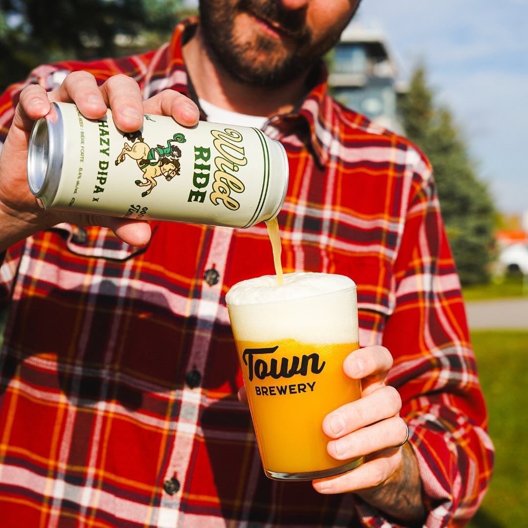 man pouring a beer