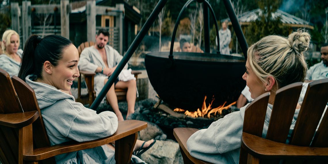 guests relaxing around a cauldron