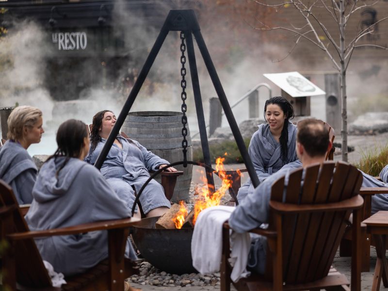 guests around an outdoor firepit at the spa