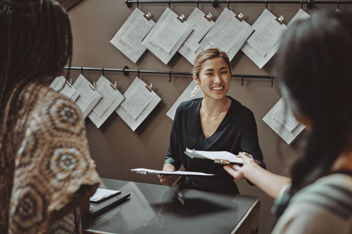 employee distributing menus to guests