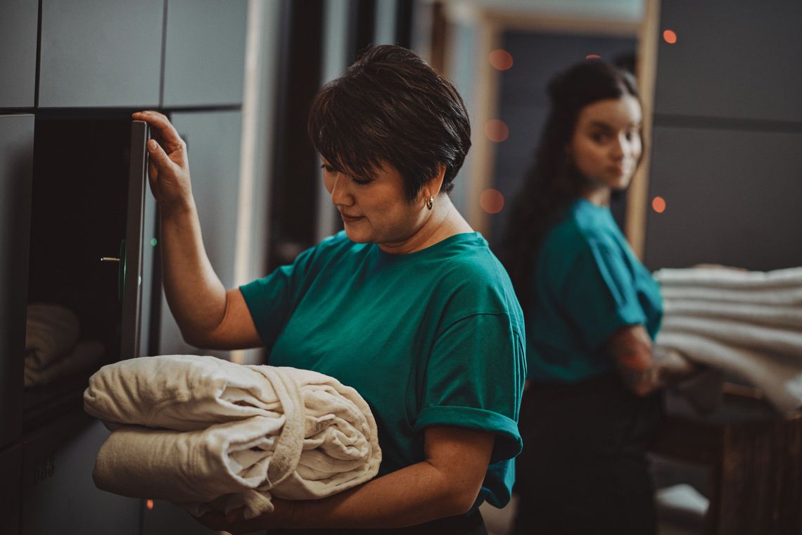 employees filling the lockers with fresh robes