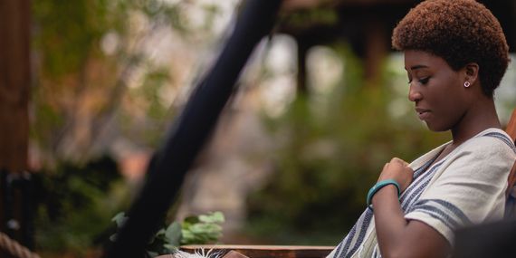 woman sitting outside at the spa village
