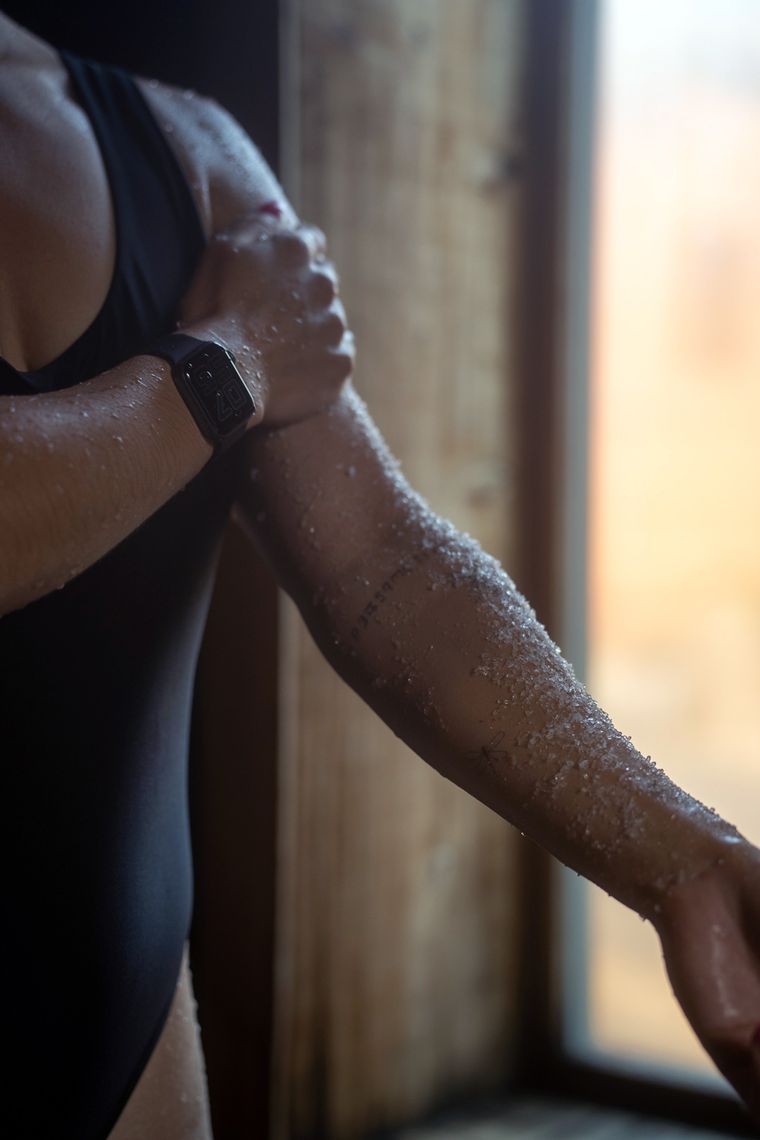 woman exfoliating her arm