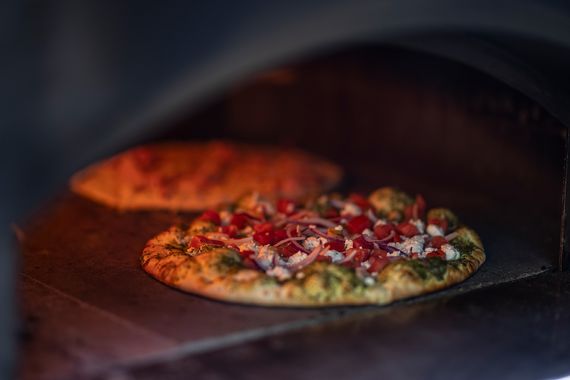 pizzas in a wood oven