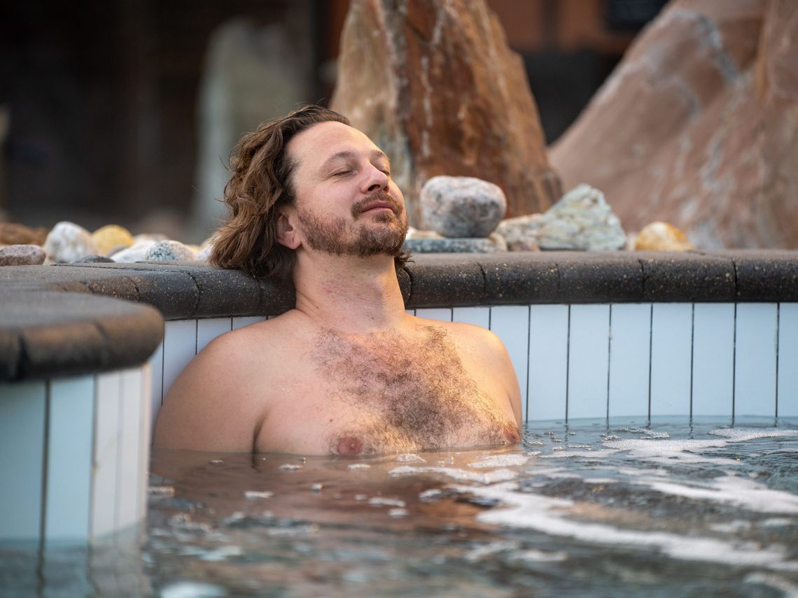 man resting in a thermal bath