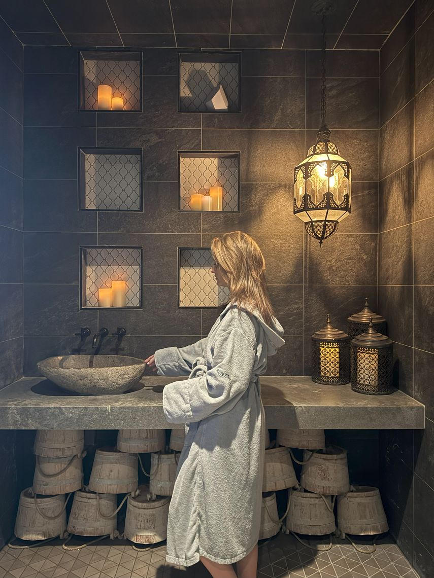 woman by the sink near the steam sauna