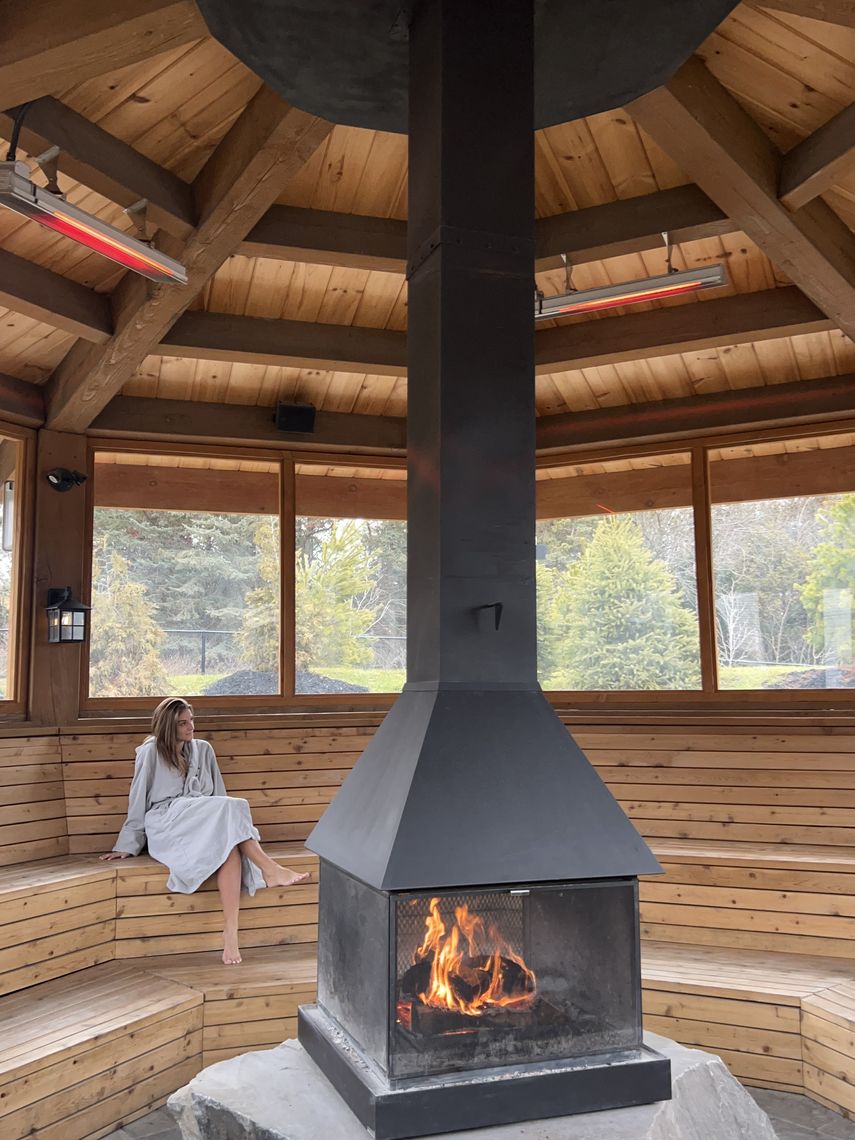 woman by the fire inside a pergola