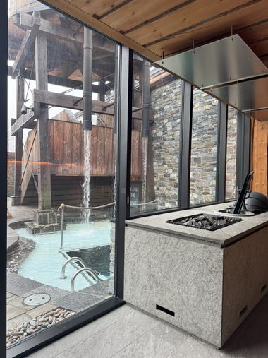 view of the village through the windows of a sauna