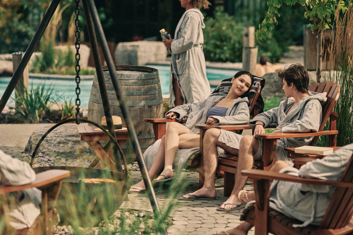 guest relaxing around a fireplace