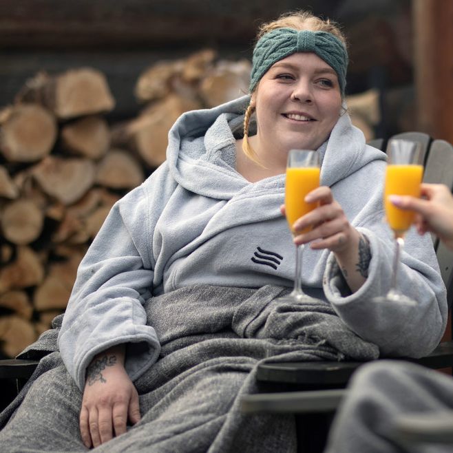 Calypso holding a drink while relaxing at the spa