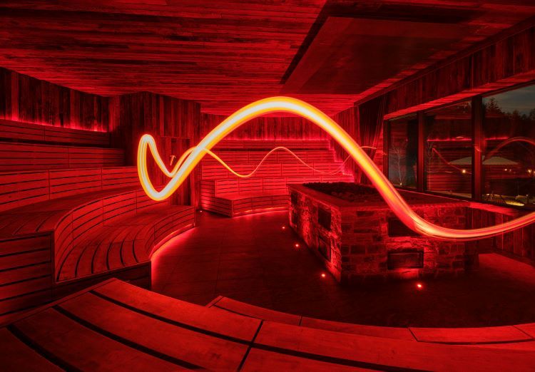 long-exposure photo of a sauna illuminated by red lights
