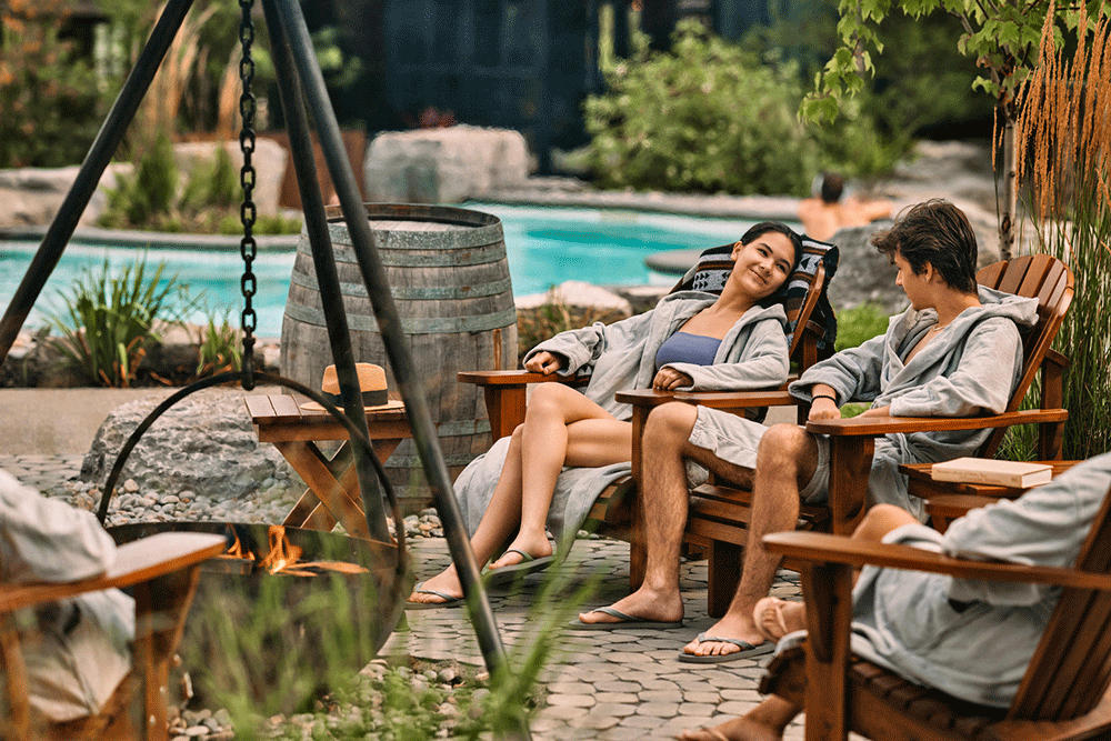 guest relaxing around a fireplace