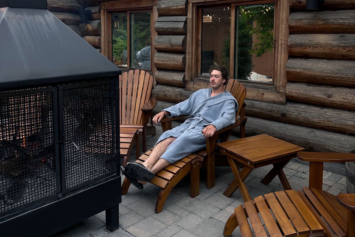guest resting near an outdoor fireplace