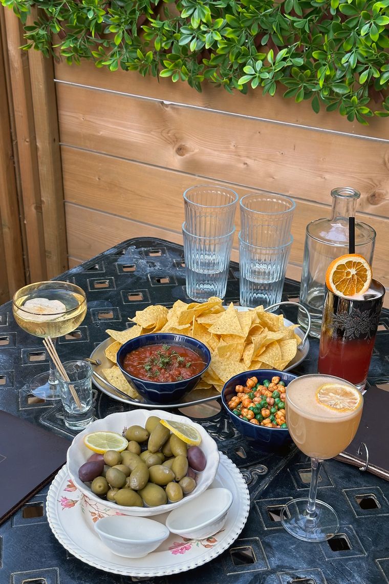 a patio table set for drinks and snacks