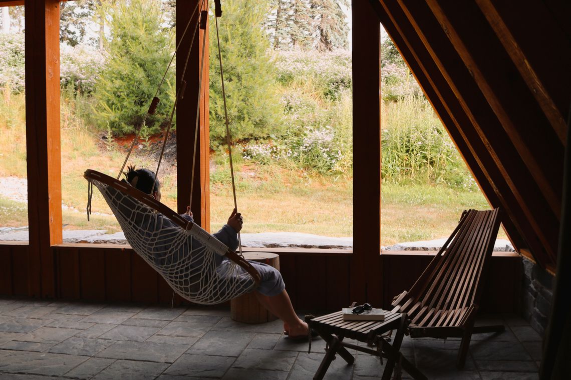 woman relaxing in a hanging chair