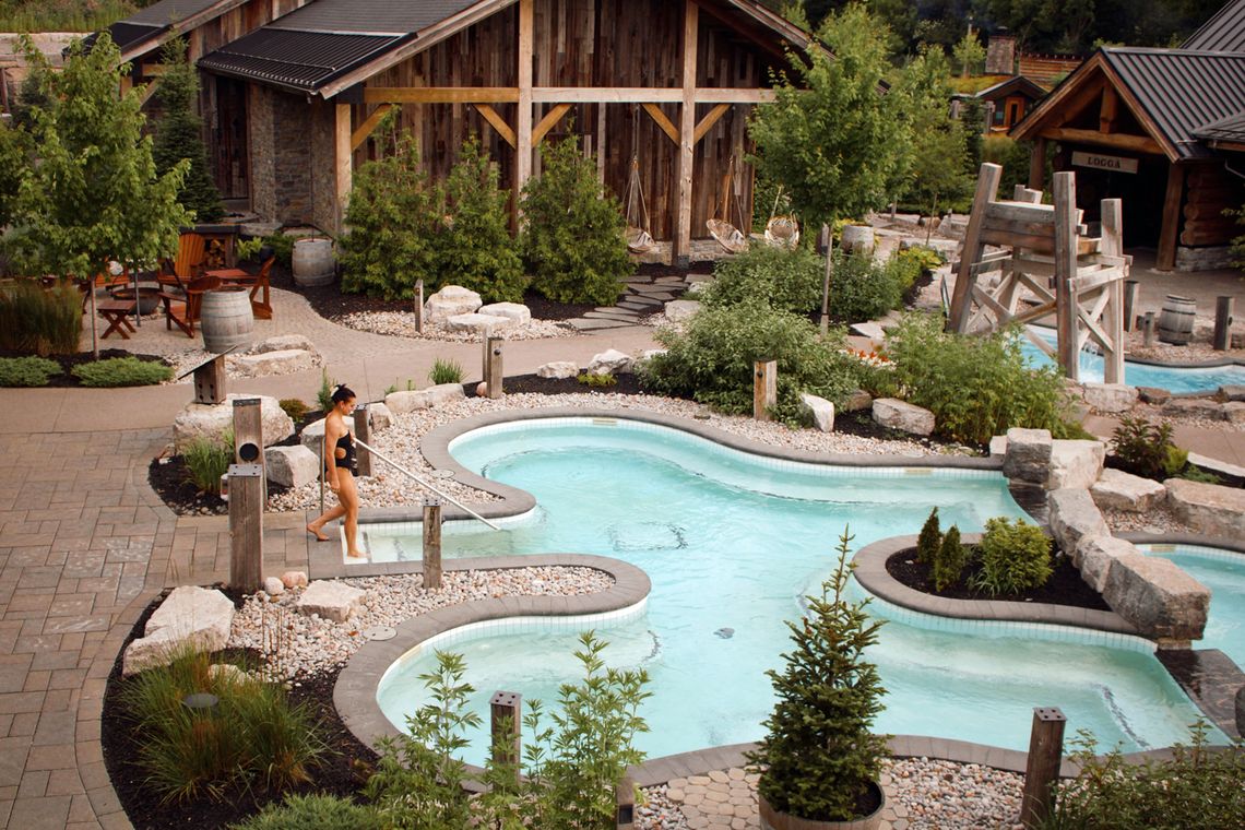 woman entering a bath in the Spa Village