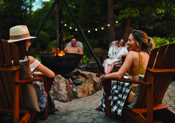 guests sitting around a fire cauldron