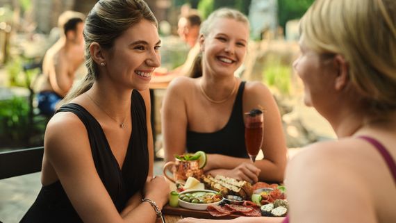 women enjoying a meal on a patio