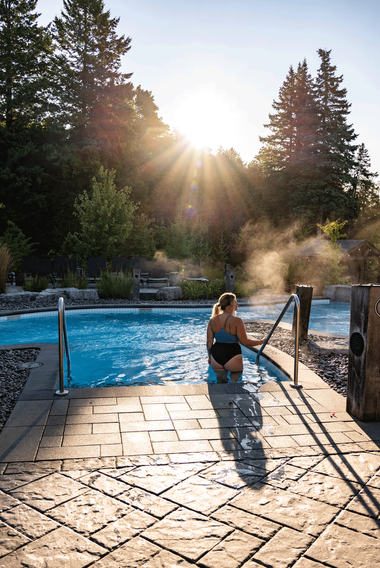 Katie entering a thermal bath on a sunny morning