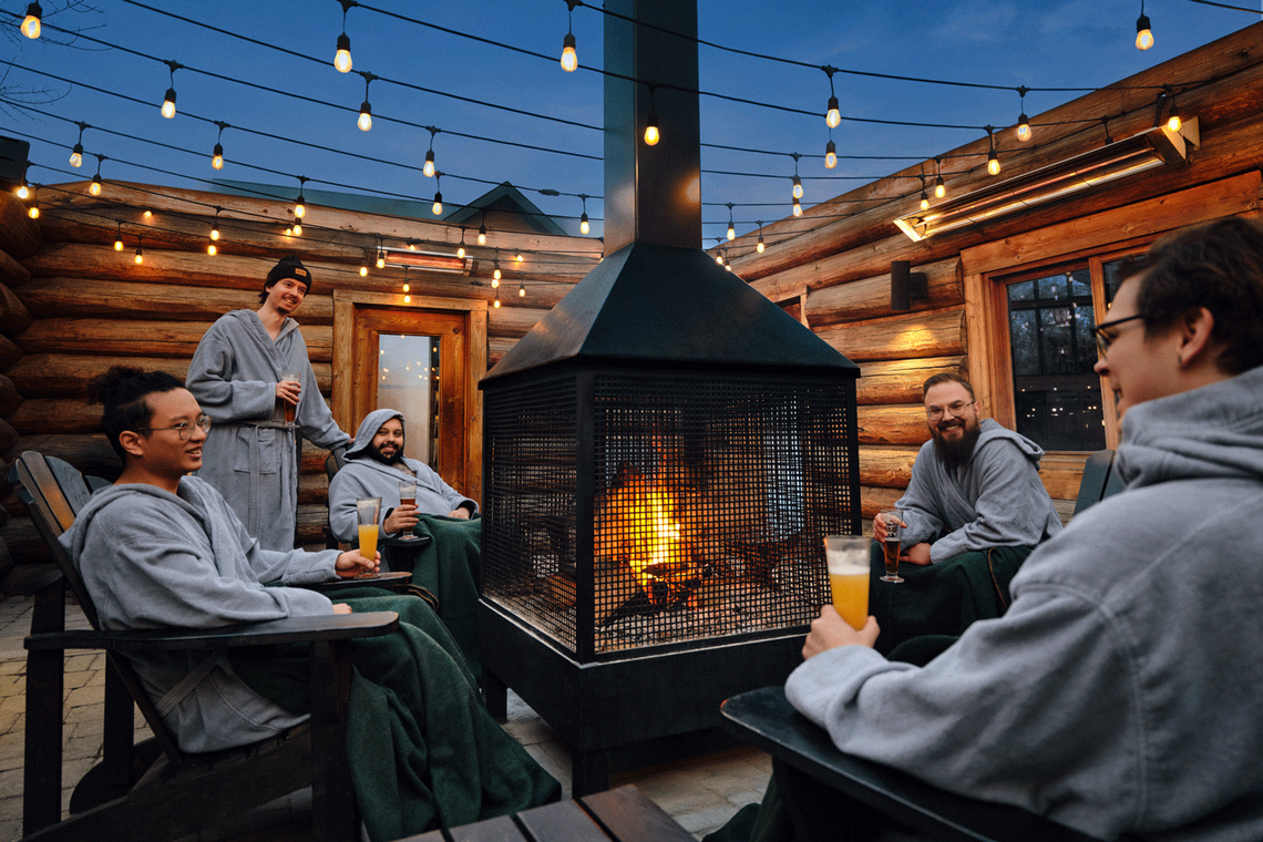 guests having a good time around an outdoor fireplace