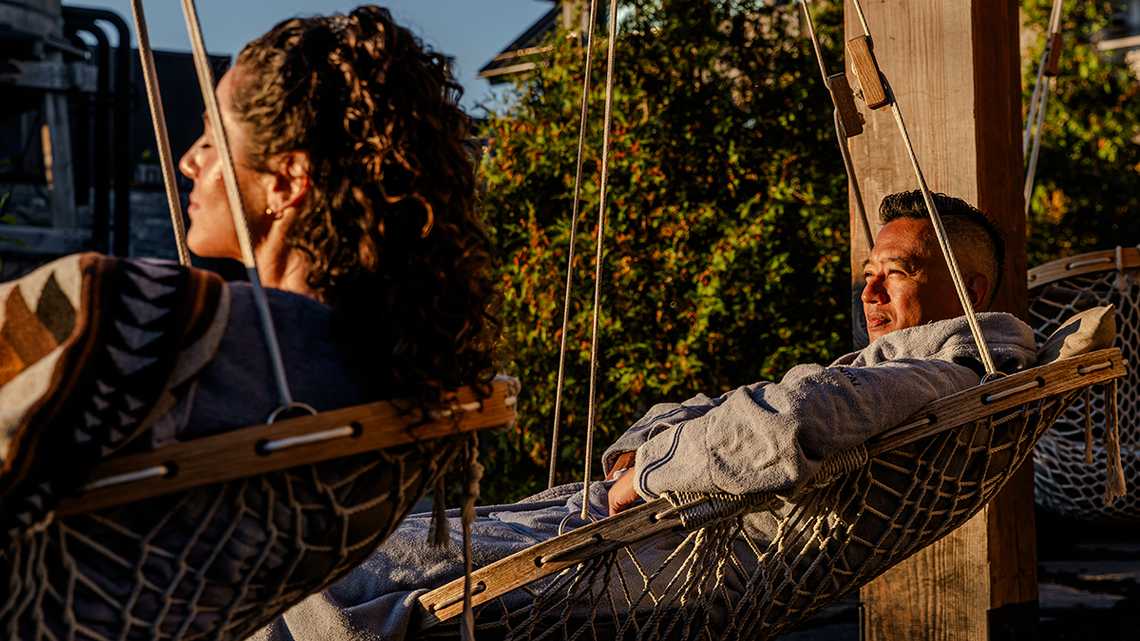 Guests relaxing outdoor in hanging chairs