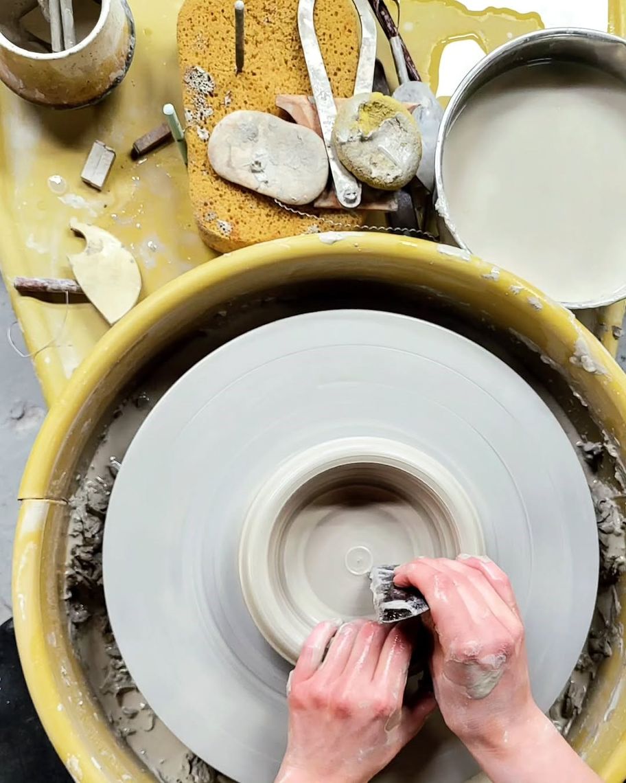 person doing pottery