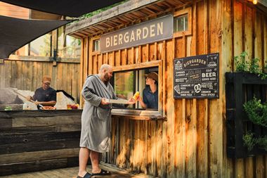 guest picking up an order from the Biergarden