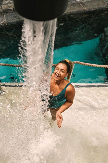 woman under a cold waterfall