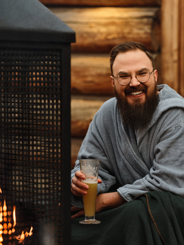 guest relaxing near a fireplace